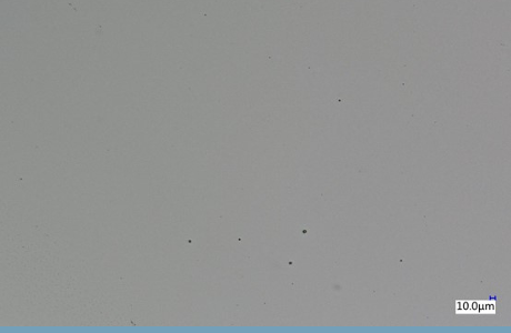 ICP DLC surface micrograph with sparse dark features and a 10 micrometre scale marker.