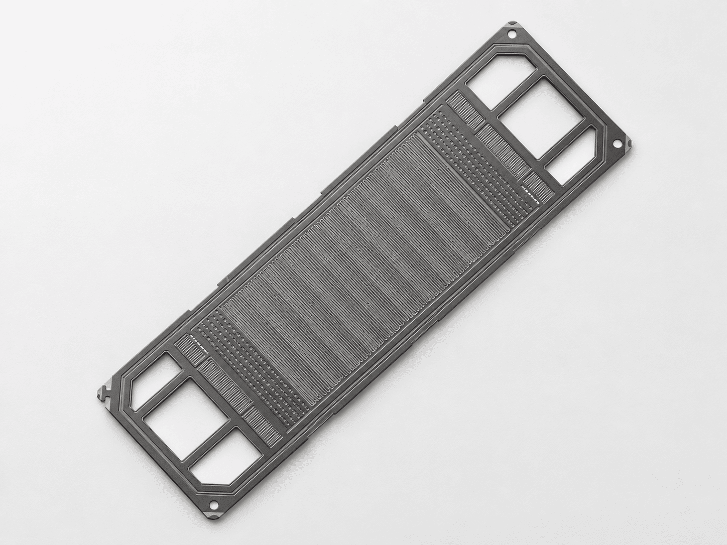Product illustration of a metallic bipolar plate with formed flow channels and manifold openings