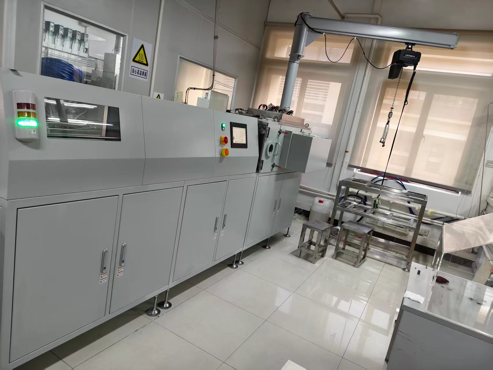 NTI coating equipment and a component handling station installed in a production and development facility.